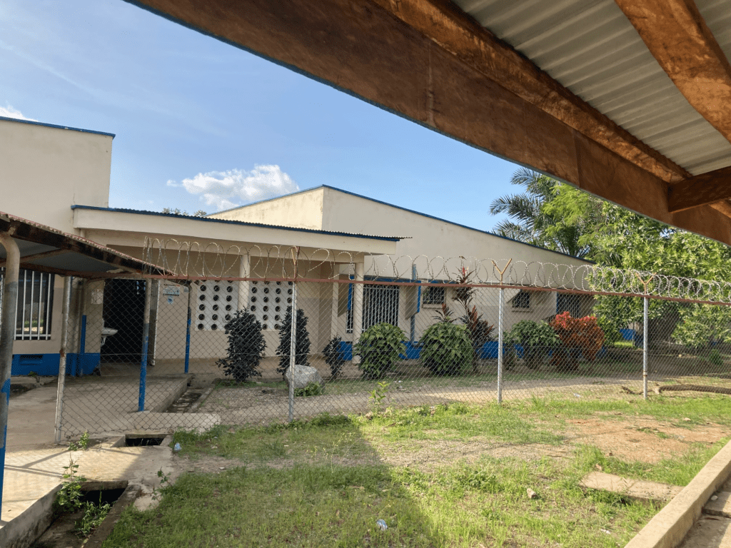 A building behind a wire fence